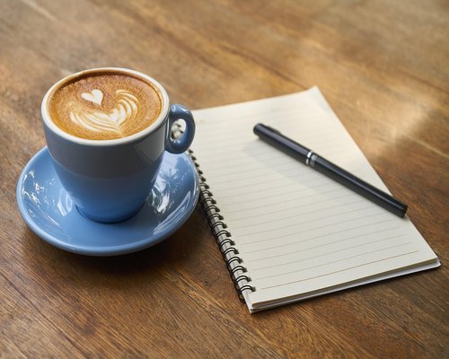 Person taking a short break with coffee away from their laptop screen